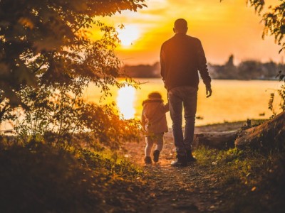 Grandpa and Grandson walking at sunset